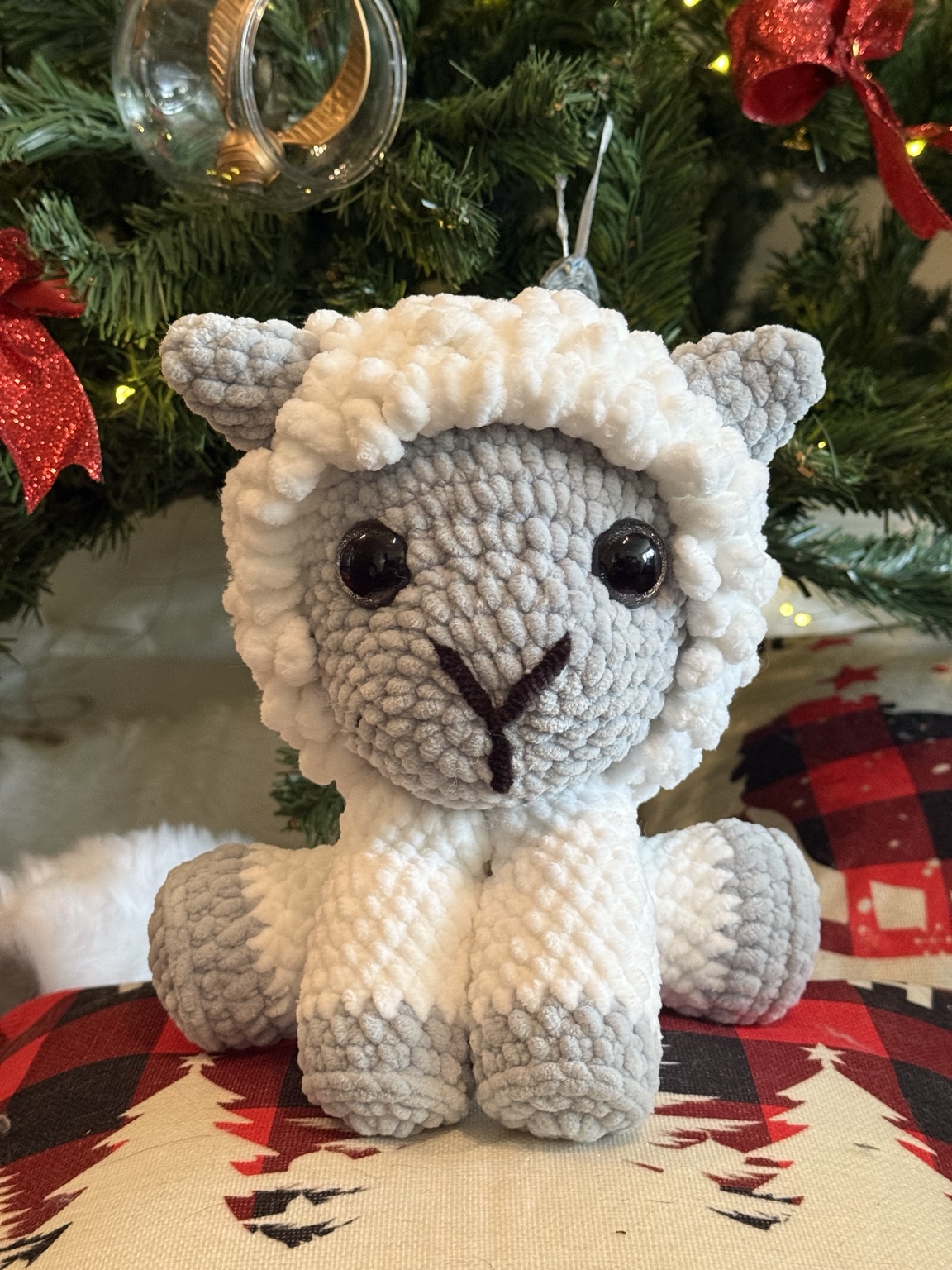 Cream and gray crochet sheep with a fluffy textured head.